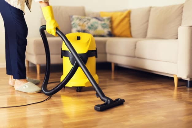 woman cleaning sofa with yellow vacuum cleaner copy space cleaning service concept 80743 542